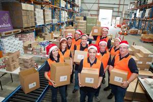 Resplendent in Santa hats, the CHEP team packed more than 500 Christmas hampers for Foodbank.